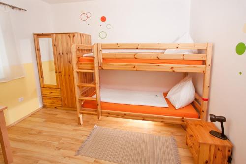 a room with two bunk beds and a mirror at Gasthof Spengerwirt in Hirschegg Rein
