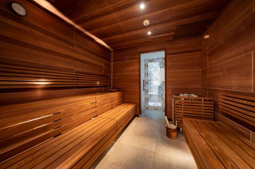 a sauna with wooden walls and wooden benches at Parkhotel Graz - Traditional Luxury in Graz
