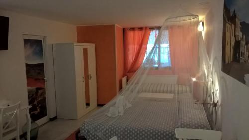 a bedroom with a bed and a window at Casetta delle Fate , sport e natura in Noli