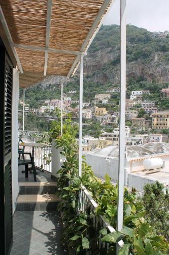 a balcony of a house with a view of a city at Hotel Reginella in Positano