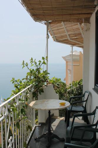 a table and chairs on the balcony of a house at Hotel Reginella in Positano