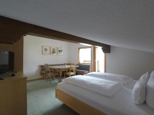 a hotel room with a bed and a dining room at Ferienhaus Bergland in Bizau