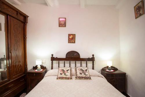 a bedroom with a large bed with two night stands at Pensión Santa Rosa in Samos