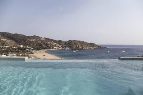 a large body of water with a beach in the background at Hide Out Suites in Mylopotas