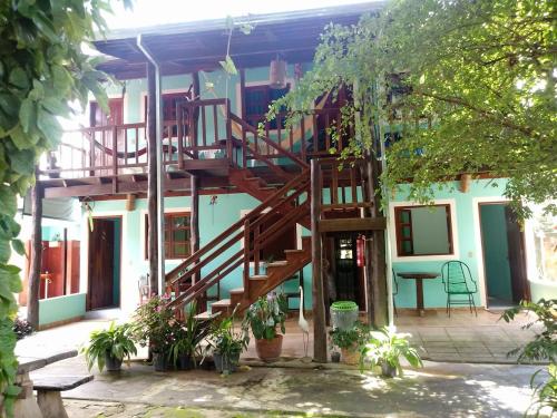 a building with a spiral staircase on the side of it at Pousada Nenzinha in Sao Jorge