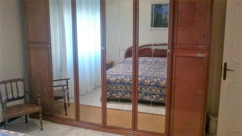 a bedroom with a bed and a glass closet at B&B In Centro in San Benedetto del Tronto
