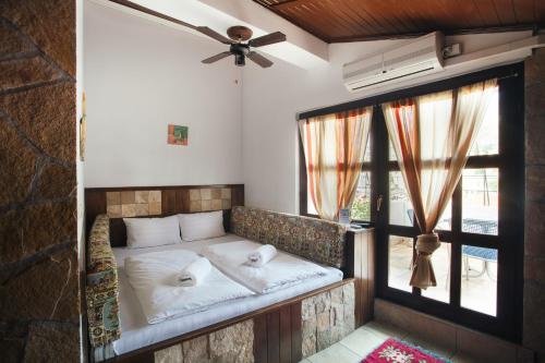 a bed in a room with a window at Villa Anri in Mostar