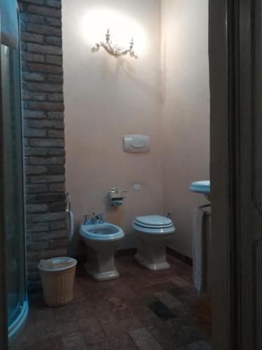 a bathroom with a toilet and a sink at Hospitale I Mori in Asola