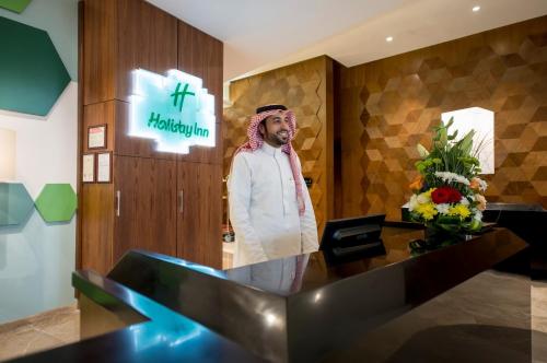 a man standing in the lobby of a hospital at Makkah Al Aziziah in Makkah