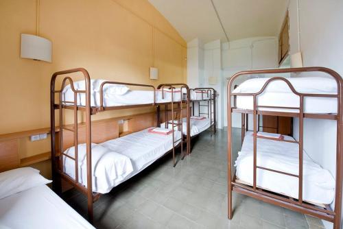 a group of bunk beds in a room at Alberg Solidança Hostel in Palafrugell