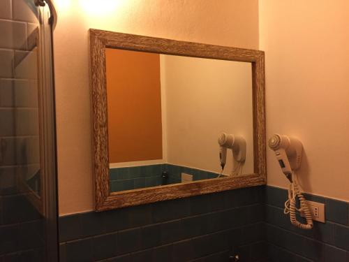 a mirror in a bathroom with a blow dryer at Rio Groppo Guesthouse in Manarola
