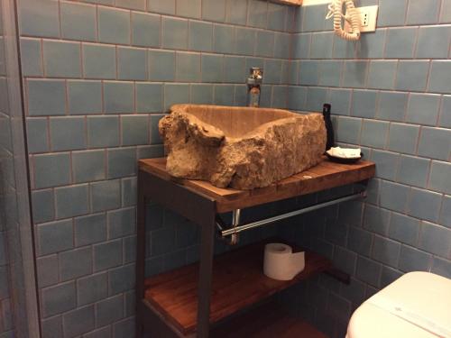 a stone sink in a bathroom with a toilet at Rio Groppo Guesthouse in Manarola