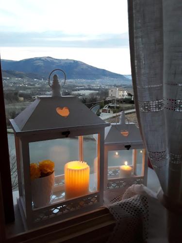 a lantern with candles on a window with a view at Locanda Bellavista in Cavaso del Tomba