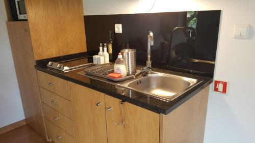 a kitchen with a sink and a counter top at Quinta Do Acipreste (Antiga Quinta Da Torre) in Lamego