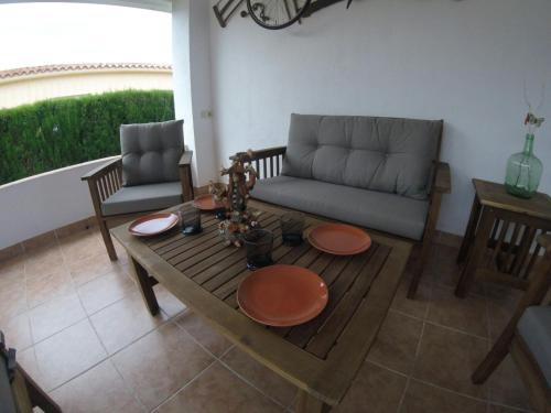 a living room with a couch and a table at Chalet Bri in Peñíscola