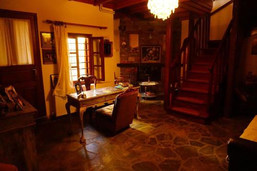 a living room with a table and a staircase at Kallisto Traditional Guesthouse in Litochoro