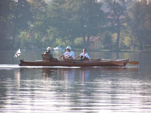 a group of people sitting in a boat on the water at Ferien in Himmelpfort in Himmelpfort