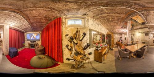 a room with a red curtain and a fake tree at Carli's Base Camp in Friedrichshafen