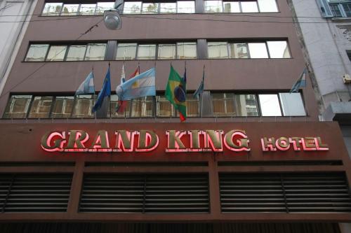 a sign for a grand king hotel with flags on it at Grand King Hotel in Buenos Aires