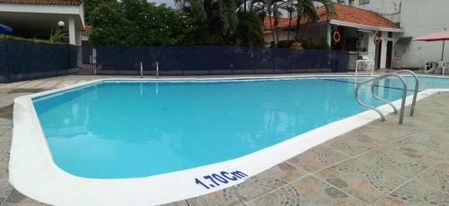 a large swimming pool with blue water at Hotel Villa Ricaurte in Girardot