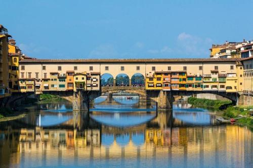 a bridge over a river with reflections in the water at Il Casolare in Penna