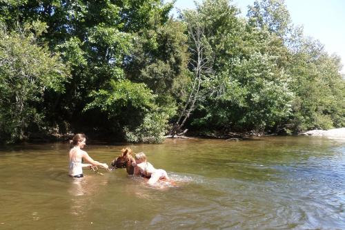 three children playing in the water in a river at Maison d'Hôtes de Charme de Croccano in Sartène