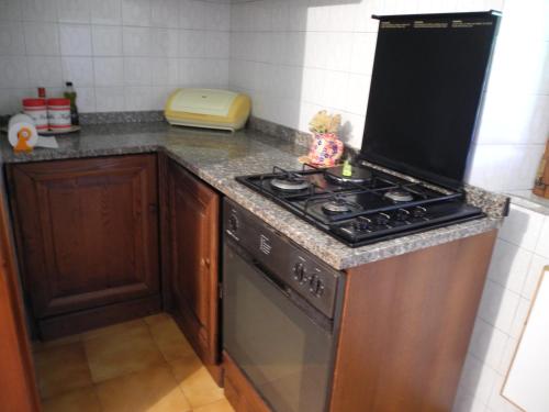 a kitchen with a stove and a counter top at Borgo Medioevale in Roccastrada