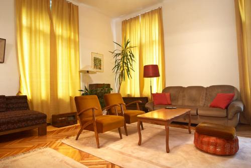 a living room filled with furniture and a large window at Hostel Residence in Sarajevo