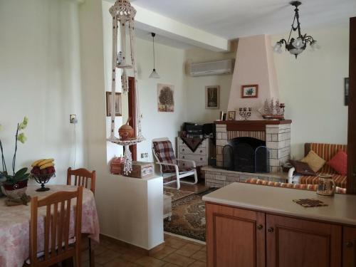 a kitchen and a living room with a fireplace at Pelion Platanidia seaside house in Platanidia