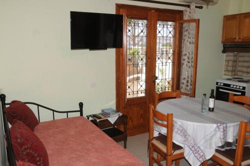 a living room with a table and a kitchen at Ekavi Apartments in Sitia