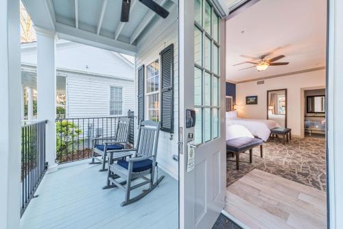 a room with a balcony with a bed and a bedroom at The Beaufort Inn in Beaufort