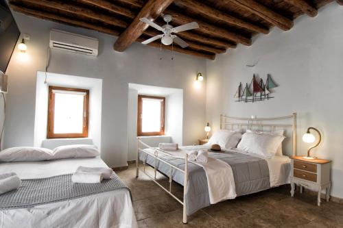 A bed or beds in a room at Gavrion's Nest - Premium Cycladic Studio