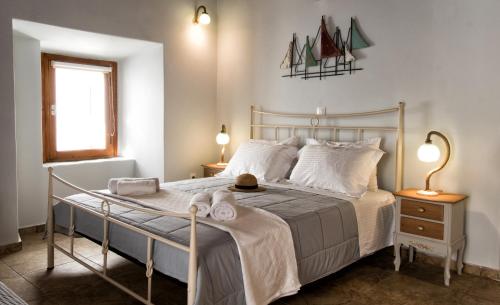 a bedroom with a bed with towels on it at Gavrion's Nest - Premium Cycladic Studio in Gavrion