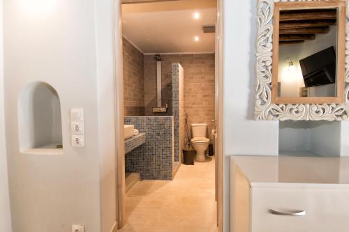 łazienka z toaletą i lustrem w obiekcie Gavrion's Nest - Premium Cycladic Studio w mieście Gavrion