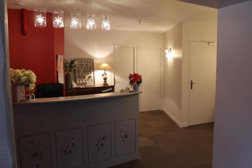 a room with a reception desk and a hallway at Hôtel Restaurant Le Moulin de Saint Verand in Saint-Vérand