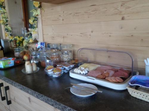 a counter top with meat and other food on it at Berggasthaus Kraxenberger in Brannenburg