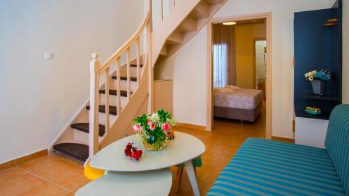 a living room with a table and a staircase at Maribella Residence Old Town Rethymno in Rethymno
