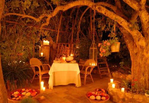 a table and chairs with candles in a garden at Son Mercadal in Porreres