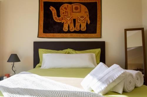 a bedroom with a bed with towels on it at PERFECT DUPLEX PISCINE Zone VIP Funchal in Funchal