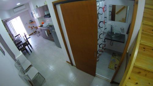 an open door to a kitchen with a table and chairs at Casa Arena San Andres in San Andrés