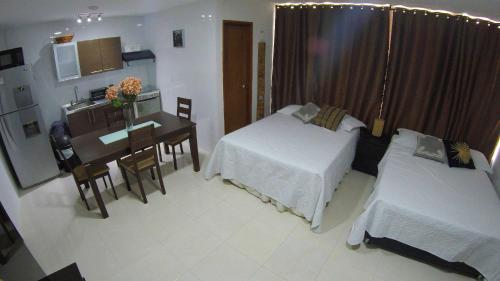 a bedroom with a desk and a bed and a table at Casa Arena San Andres in San Andrés