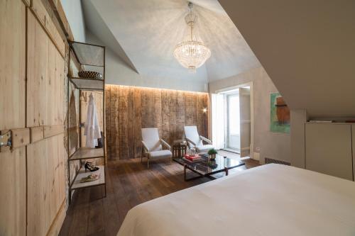 a bedroom with a bed and a living room at Dare Lisbon House in Lisbon