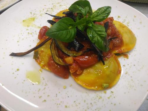 a white plate with a dish of food on it at Il Castello in Petralia Sottana
