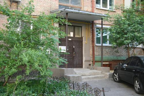 a black car parked in front of a brick building at Luxury apartment in the heart of the capital in Kyiv