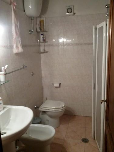 a bathroom with a toilet and a sink and a shower at La Campesa in Vagliagli