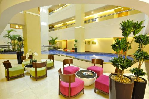 a lobby with colorful chairs and a pool at Fraser Suites Seef Bahrain in Manama