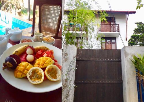 a plate of fruit and eggs on a table at Talalla Bay Beach in Talalla