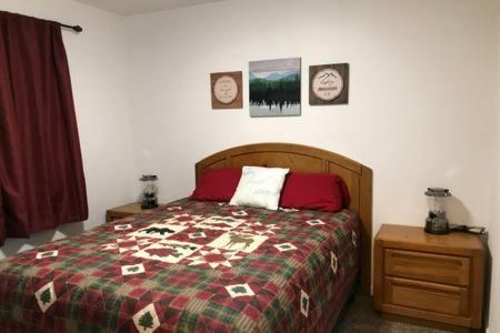 a bedroom with a bed and a nightstand with a bed sidx sidx sidx sidx at Peaceful Talkeetna Getaway #1 in Talkeetna