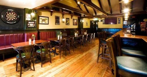 a bar with tables and chairs in a restaurant at The Farmers Kitchen Hotel in Wexford