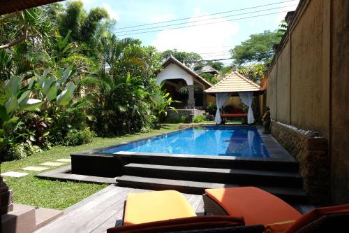 a swimming pool in the backyard of a house at Villa Celavi 77 in Jimbaran